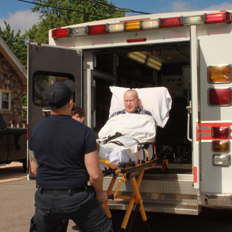 Employees loading patient